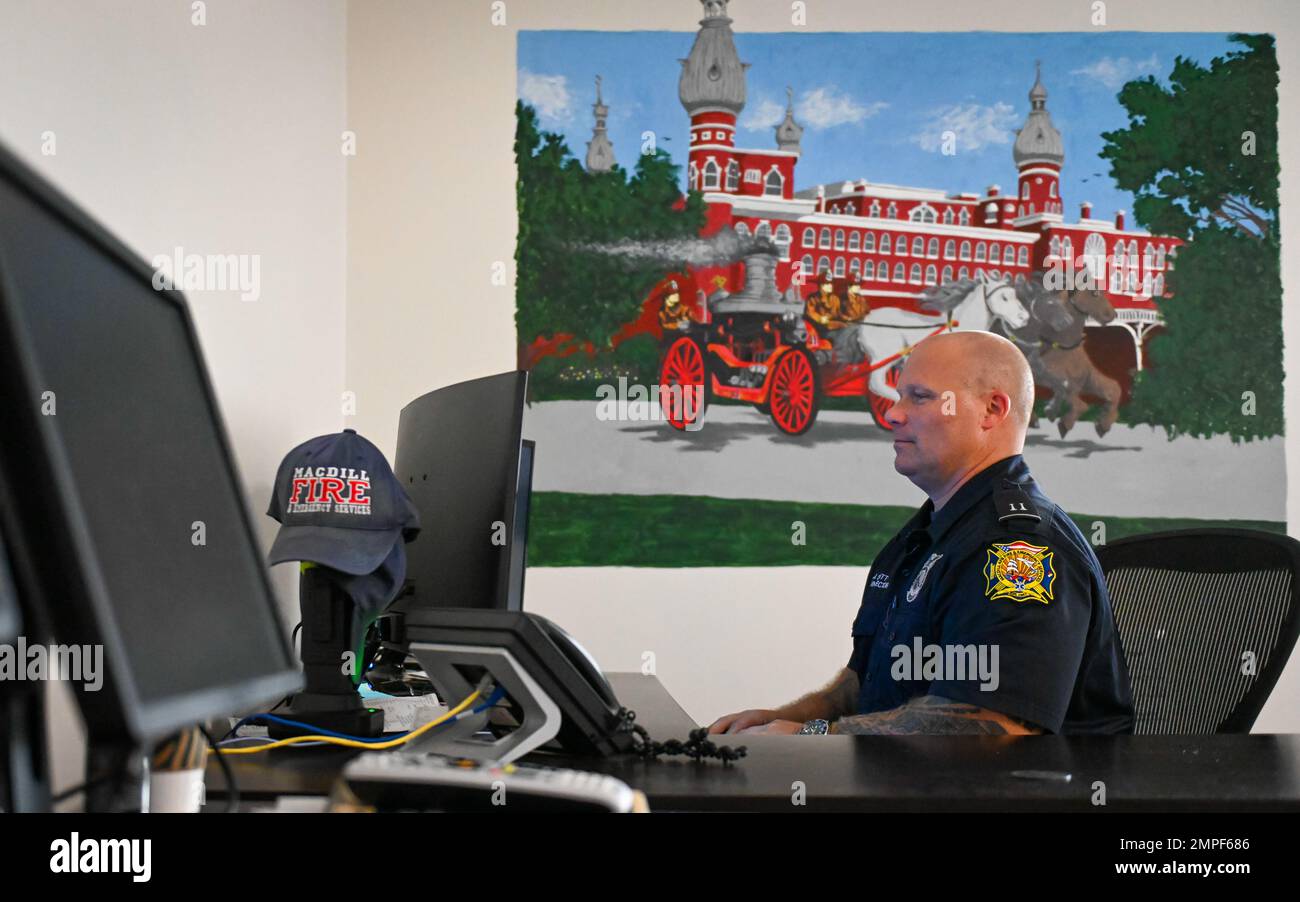 Jay Scott, a fire inspector assigned to the 6th Civil engineering Squadron works near a mural he painted at MacDill Air Force Base, Florida, Oct. 13, 2022. The mural depicts firefighters operating a horse drawn carriage near the formal Tampa Bay Hotel. A 20-year Air Force veteran with over 30 years of experience in fire prevention, Scott saw an opportunity to pay tribute to those who came before him and share those stories with new Airmen through art. Stock Photo