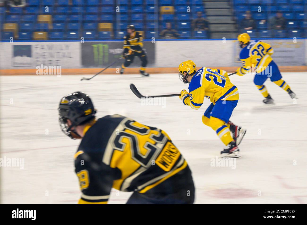 Members of the University of Alaska Fairbanks (UAF) and Michigan Technological University (MTU) hockey teams face off during a military appreciation game in Fairbanks, Alaska, Oct. 13, 2022. Also known as the ‘Nanooks’, the UAF’s hockey team played against the ‘Huskies’, MTU’s hockey team, at Carlson Center. Stock Photo