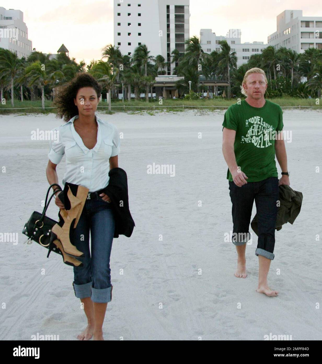 Boris Becker and Sharlely Kerssenberg go barefoot at sunset on Miami Beach. The tennis ace walked in the surf and posed on a lifeguard stand for German TV. Sharlely watched admiringly and took photos of her man and compared them with her friend's shots. Boris seemed uncomfortable to be photographed with Sharlely, while she seemed to hope for more of his attention, 10/31/06 Stock Photo