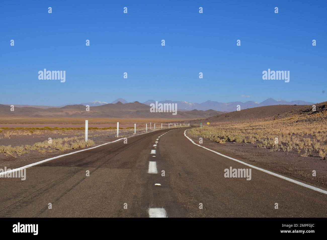 Lonely road curve desert bokeh chile South America Stock Photo
