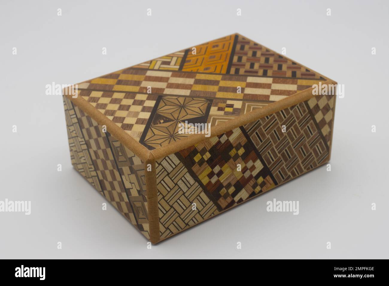 Puzzle japanese box. Wooden secret japanese box. It requires 11  moves in the correct order to be opened Stock Photo