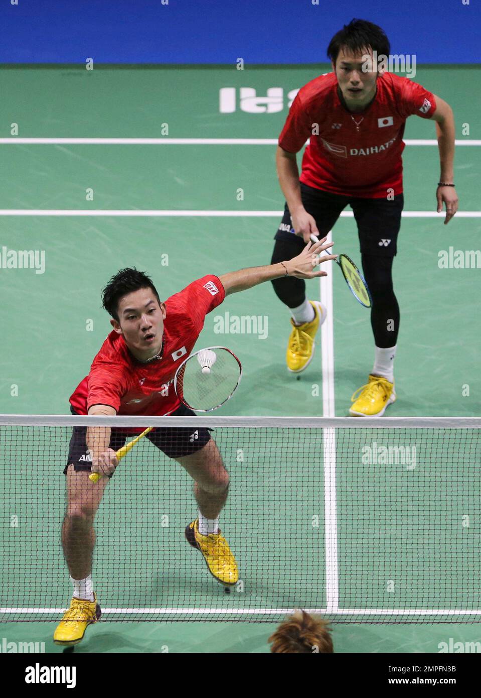 Indonesias Marcus Fernaldi Gideon, front, and Kevin Sanjaya Sukamuljo compete against Denmarks Kim Astrup and Anders Skaarup Rasmussen during their mens doubles badminton group stage match at the BWF World Tour Finals