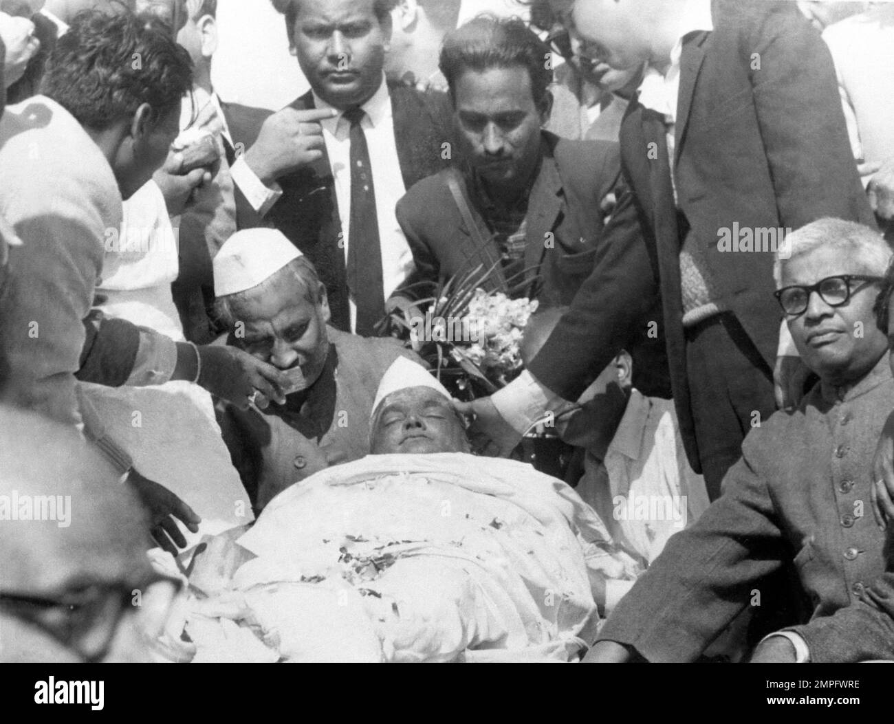 Relatives and friends gather round the body of Indian Premier Lal ...