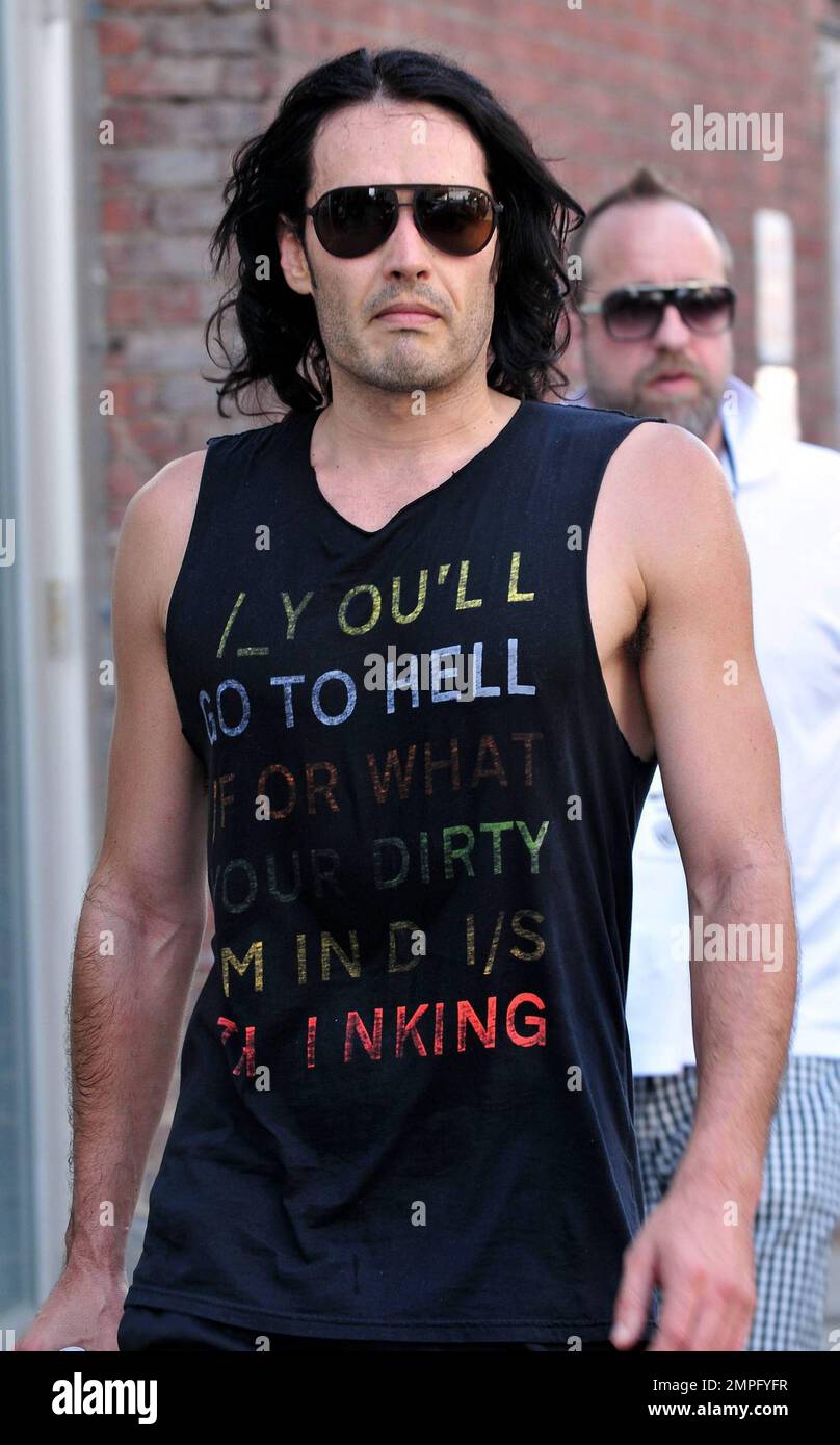 Russell Brand wears workout gear, including a sleeveless shirt that reads 'You'll go to hell for what your dirty mind is thinking,' as he heads to his trailer to change. He later emerges in a tan suit, black shirt and flip flops on the set of his new film, a remake of the 1981 hit 'Arthur.' In the film, he plays the role of Arthur, originally played by Dudley Moore. Brand is joined in the film by Helen Mirren, who plays his butler, a role that originally won Sir John Gielgud his only Oscar. Mirren was also spotted on set wearing a blue polka-dot head wrap, sunglasses, white top and pleated ski Stock Photo