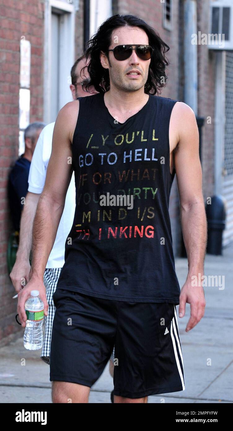 Russell Brand wears workout gear, including a sleeveless shirt that reads 'You'll go to hell for what your dirty mind is thinking,' as he heads to his trailer to change. He later emerges in a tan suit, black shirt and flip flops on the set of his new film, a remake of the 1981 hit 'Arthur.' In the film, he plays the role of Arthur, originally played by Dudley Moore. Brand is joined in the film by Helen Mirren, who plays his butler, a role that originally won Sir John Gielgud his only Oscar. Mirren was also spotted on set wearing a blue polka-dot head wrap, sunglasses, white top and pleated ski Stock Photo