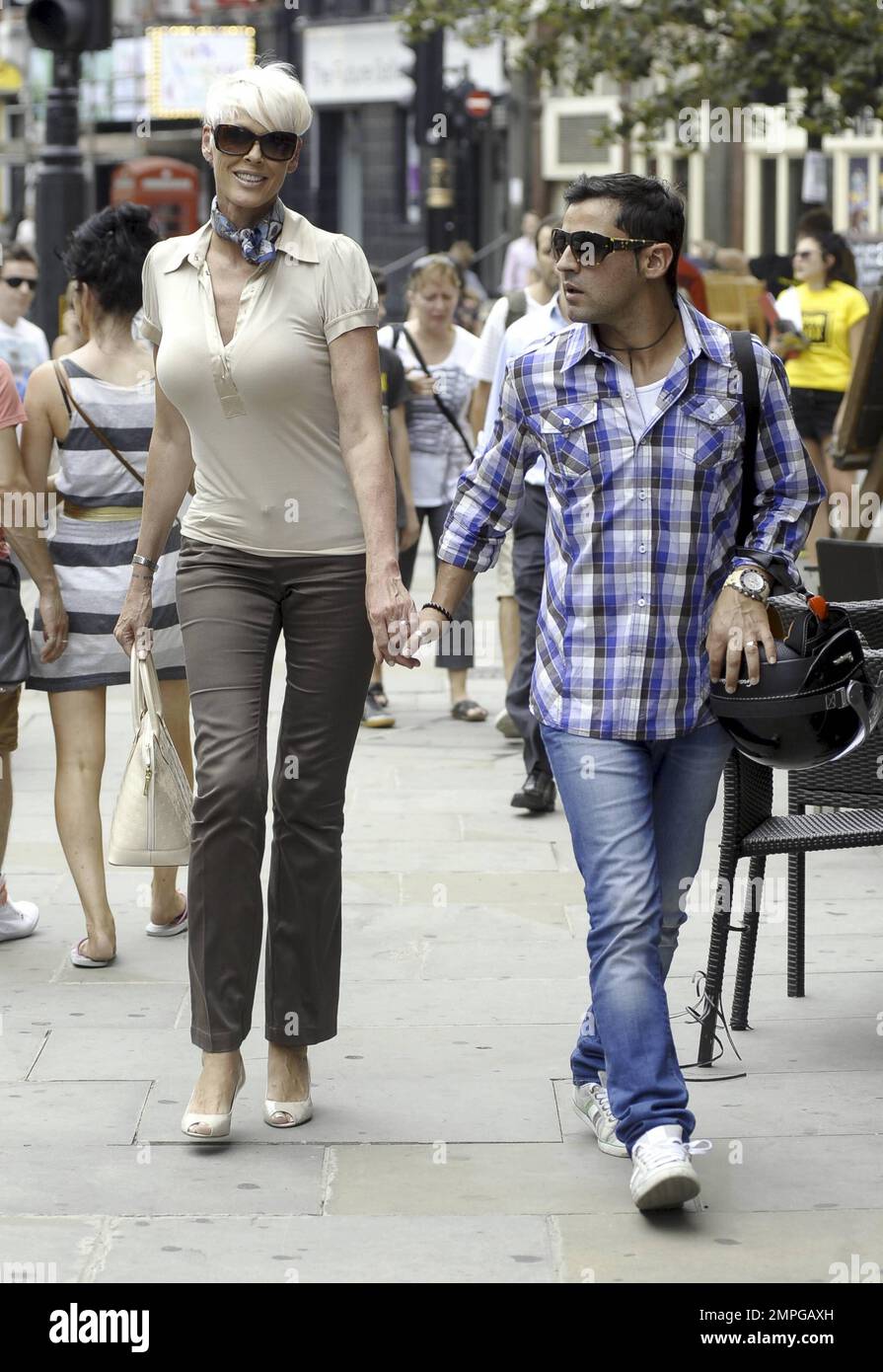 Brigitte Nielsen And Her Husband Walk Hand-in-hand While Out For A