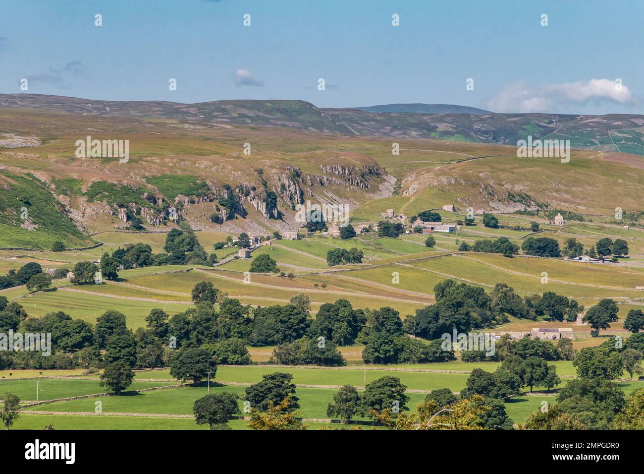 The remote hamlet of Holwick, Upper Teesdale, basking in summer sunshine beneath the cliff of Holwick Scar. Stock Photo