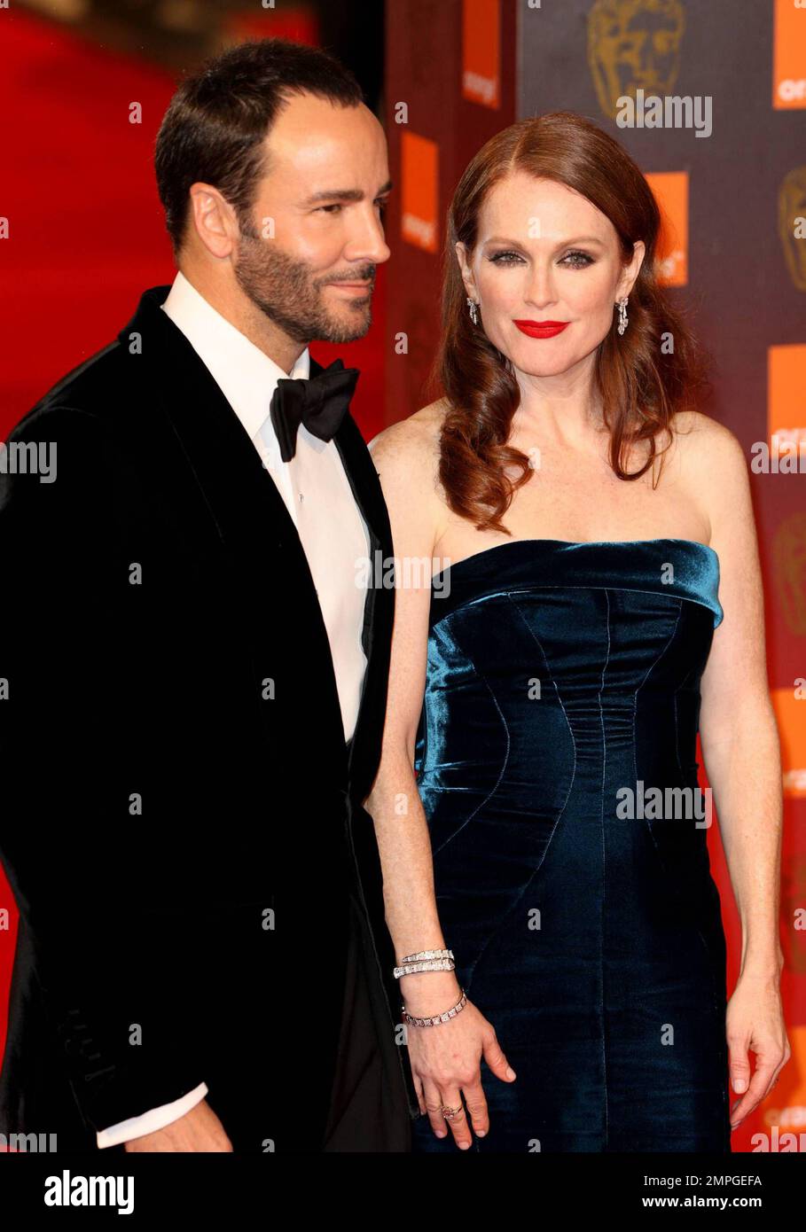 Tom Ford and Julianne Moore pose for photographers on the red carpet at