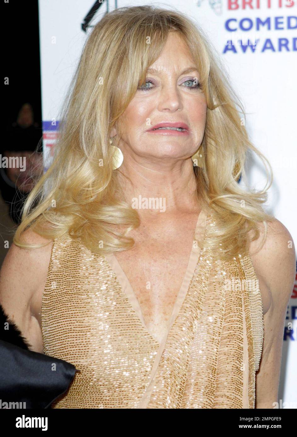 Showing off her remarkable legs Goldie Hawn, who went braless, wears a gold  v-neck cocktail dress and smiles as she arrives at the British Comedy  Awards held at the O2 Arena and