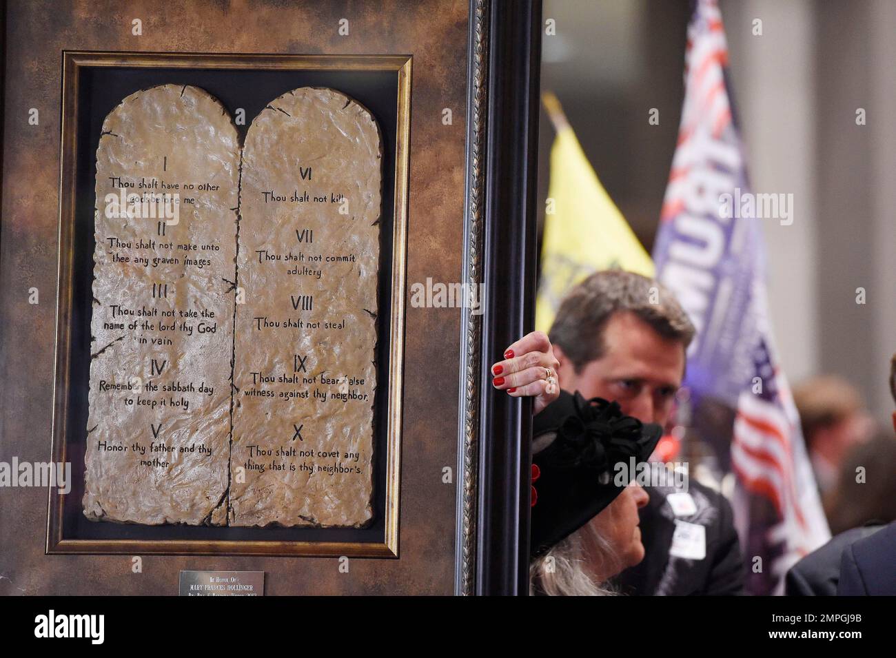 A U.S. Senate candidate Roy Moore supporter walks with a framed artwork