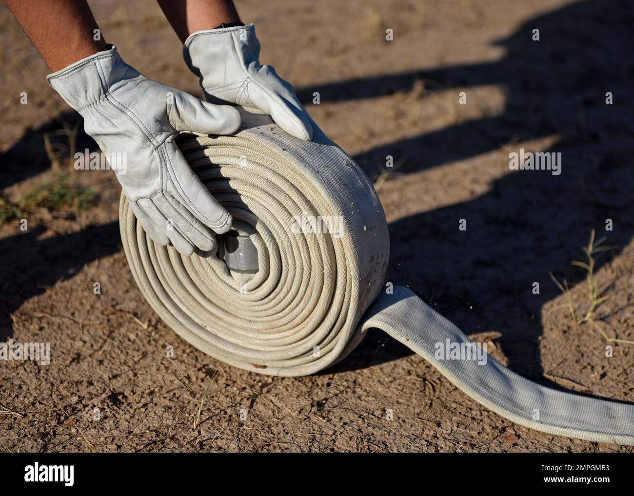 A hose is rolled during the annual Fire Muster Challenge at Goodfellow Air Force Base, Texas