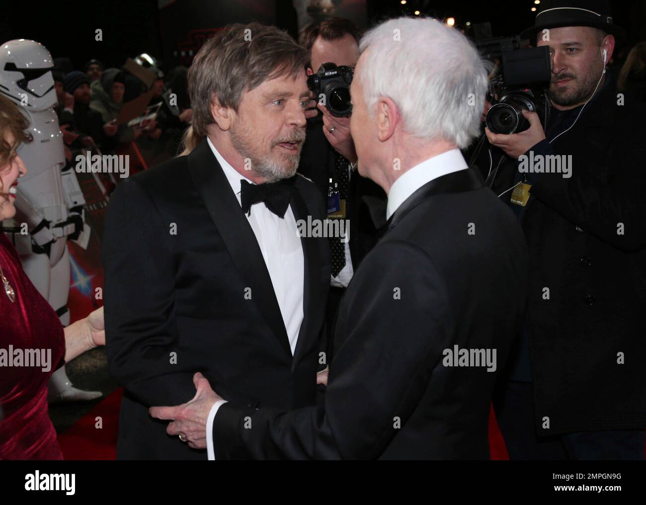 Mark Hamill, left, greets Anthony Daniels before they pose for