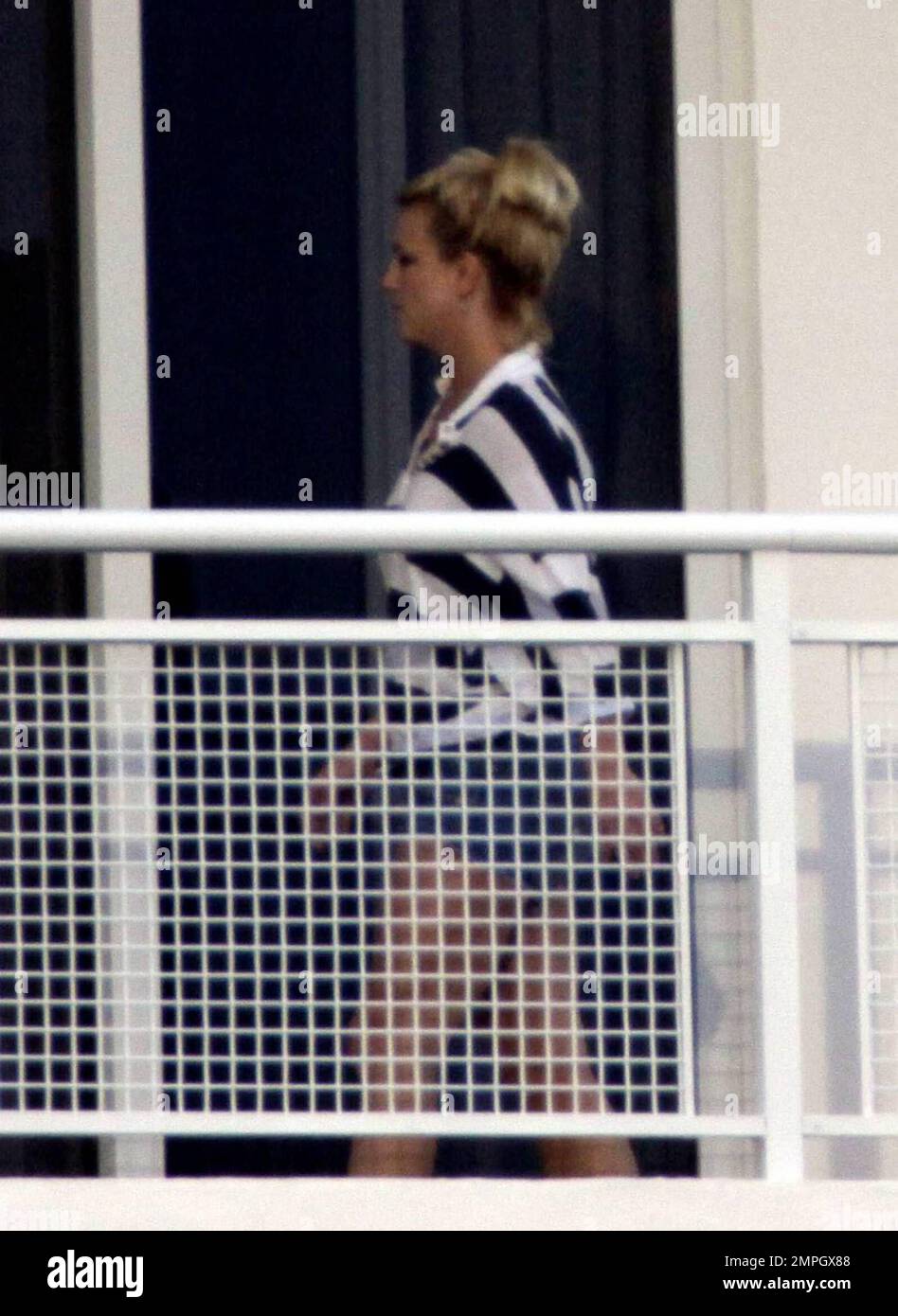 Britney Spears Wearing Daisy Dukes And A Striped Top Relaxes While Smoking A Cigarette On The