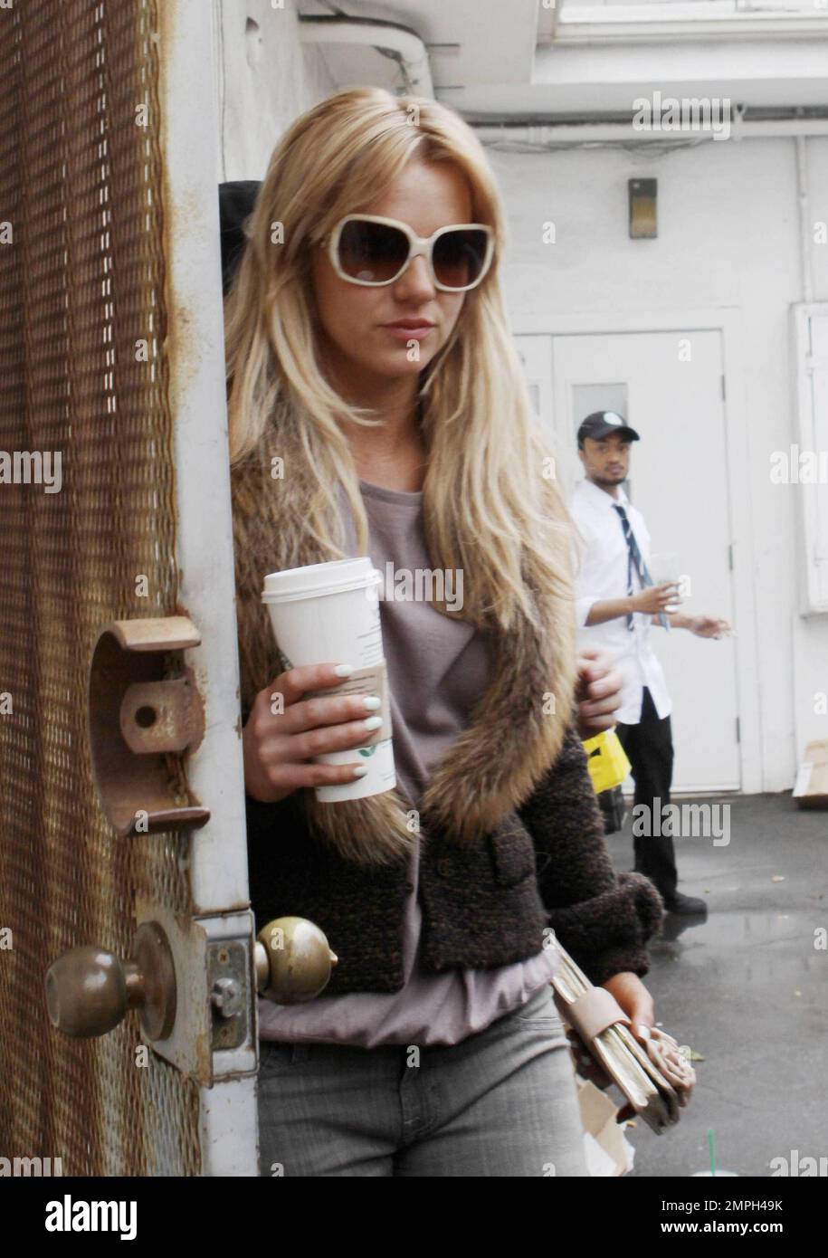 Britney Spears enjoys a coffee as she leaves the boutique after another day out