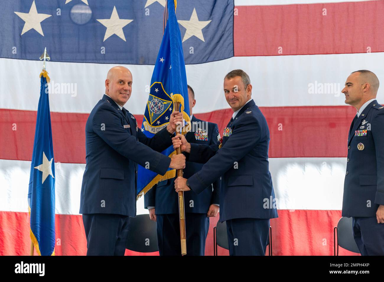 U.S. Air Force Brig. Gen. Gary McCue, Deputy Assistant Adjutant General for Air, Ohio National Guard, receives the official 180th Fighter Wing flag, officially relinquishes command of the wing from Col. Michael DiDio during a Change of Command ceremony at the 180FW in Swanton, Ohio, Oct. 15, 2022. During the ceremony, outgoing 180FW commander, DiDio, relinquished command to incoming commander, Col. Chad Holesko. Stock Photo