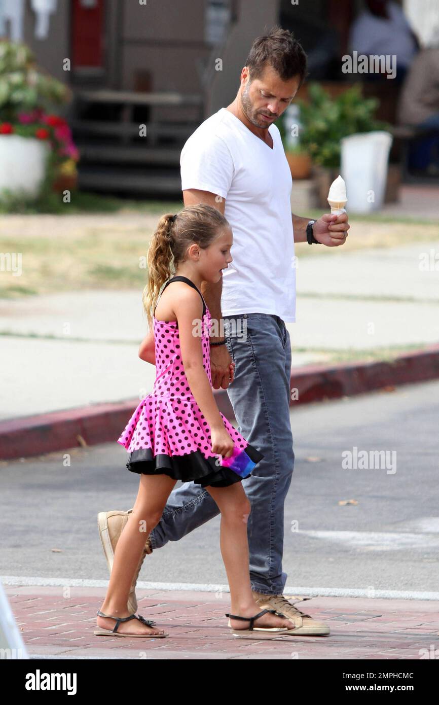 Brooke Burke, husband David Charvet and their daughter Rain were spotted at the 32nd Annual Malibu Kiwanis Chili Cook-Off, Carnival & Fair. The 41 year old TV personality wore a black floral summer dress paired off with brown boots, a straw hat and a brown purse. Malibu, CA. 31st August 2013. . Stock Photo