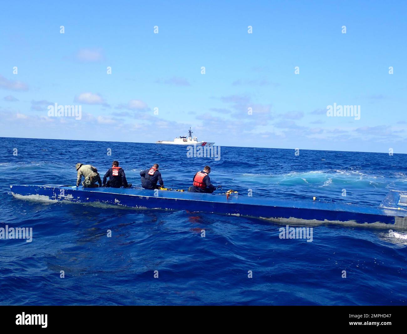 Crew from the U.S. Coast Guard Cutter Bertholf (WMSL 750) inspect a low