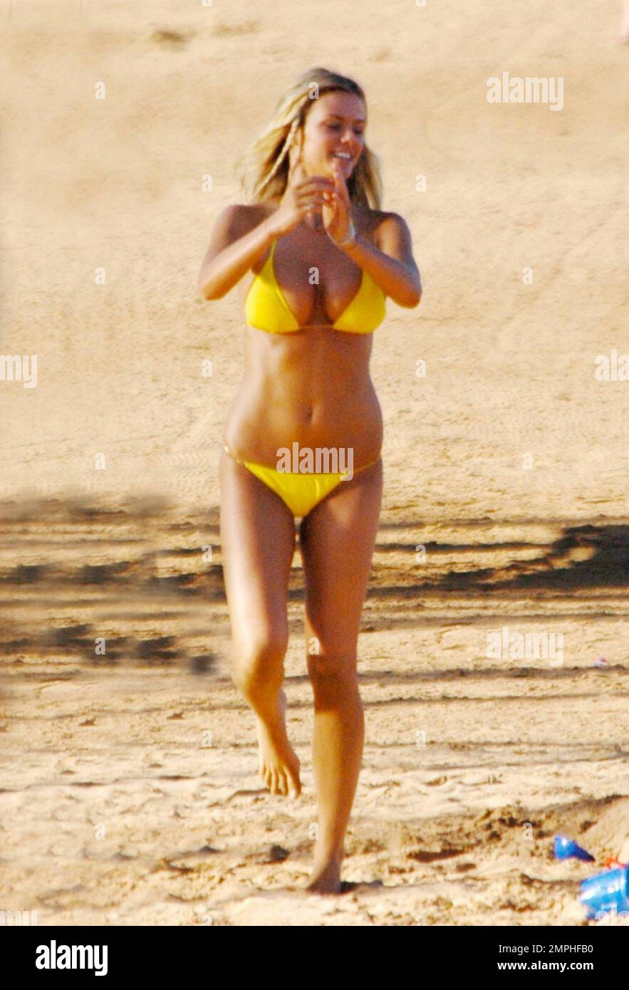 2010 "Sports Illustrated" Swimsuit Edition cover model Brooklyn Decker  wears a yellow bikini while she frolics on the beach during filming her new  film "Just Go With It." The film also stars