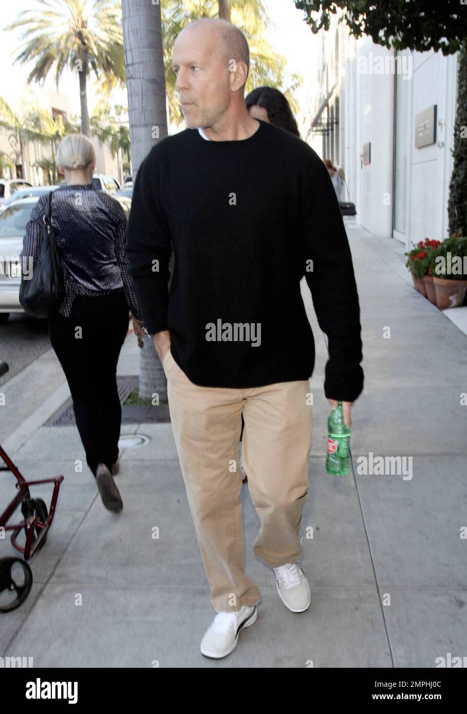 EXCLUSIVE!! Actor Bruce Willis strolls in Beverly Hills with pregnant wife Emma Heming. Bruce walked in front of Emma, 33, who kept her hand over her face. According to reports, Willis, 56, has been paying a lot of attention to ex-wife Demi Moore, providing support during her split with Ashton Kutcher. The reports say that, even though Bruce has been married to Emma for three years, he doesn't want to neglect her, but is 'Demi's closest friend,' and wants to make sure she stays strong. Beverly Hills, CA. 28th December 2011. Stock Photo