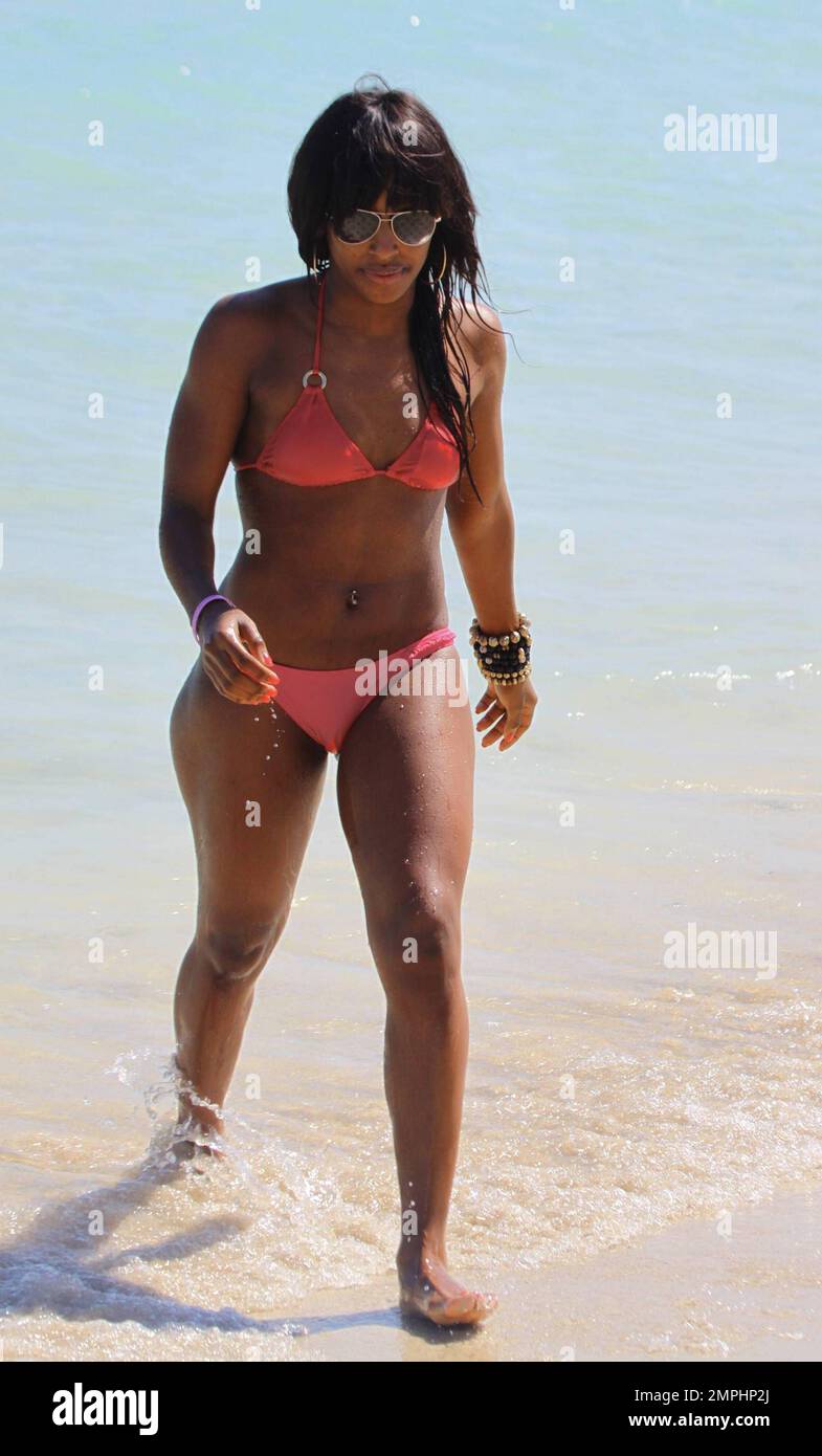 UK Singer Alexandra Burke dons a peach-colored tube top bikini for a romp  at the beach where she soaked up the sun and enjoyed a dip in the ocean.  The "X Factor"