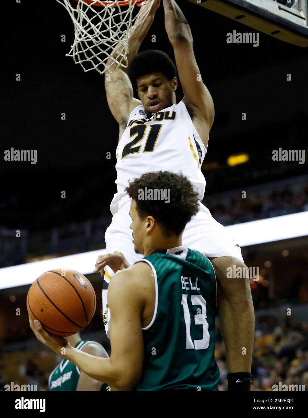 Missouri's Jordan Barnett (21) dunks over Green Bay's Trevian Bell (13 ...