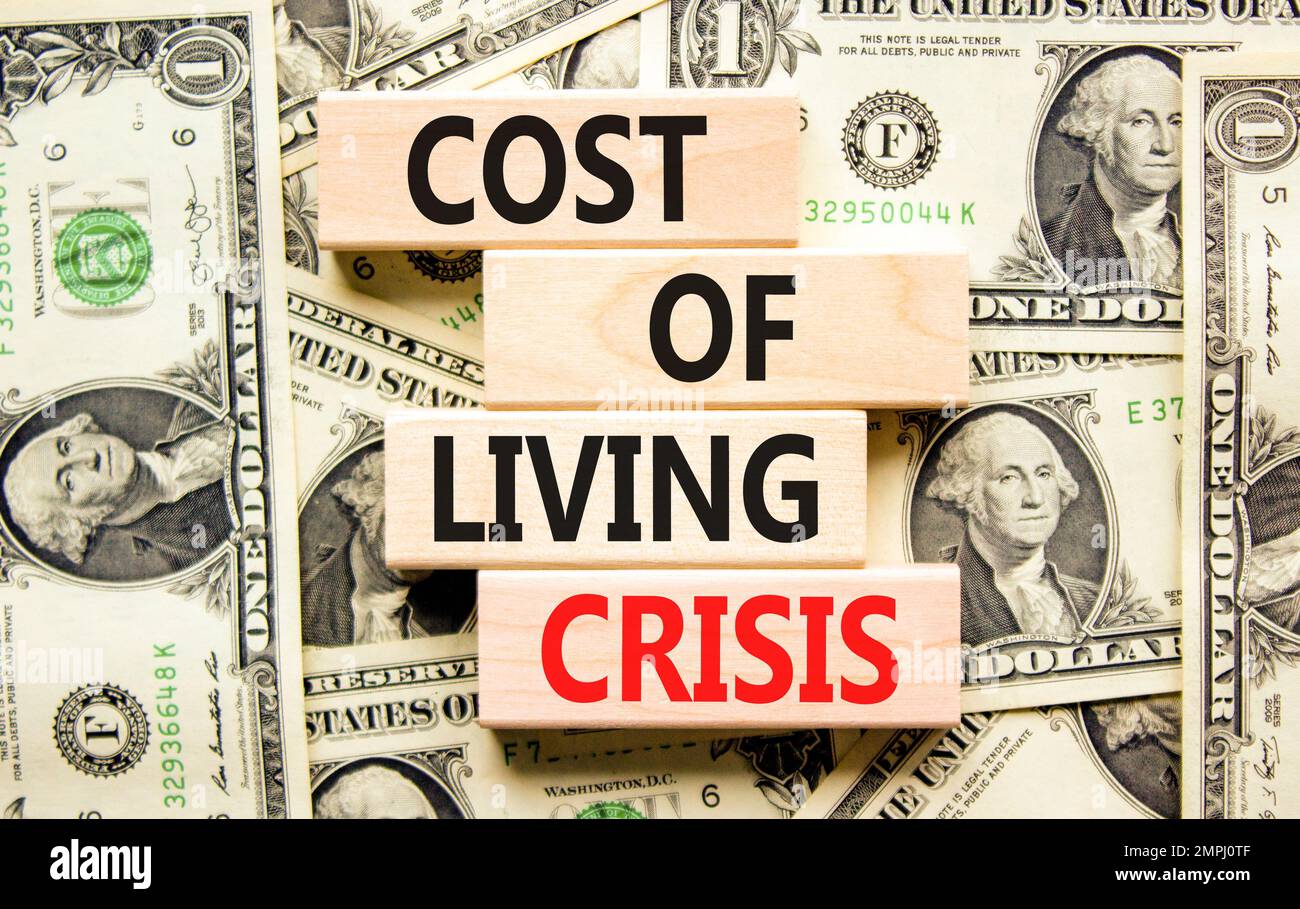 Cost of living crisis symbol. Concept words Cost of living crisis on wooden  blocks. Dollar bills. Beautiful background from dollar bills. Business cos  Stock Photo - Alamy