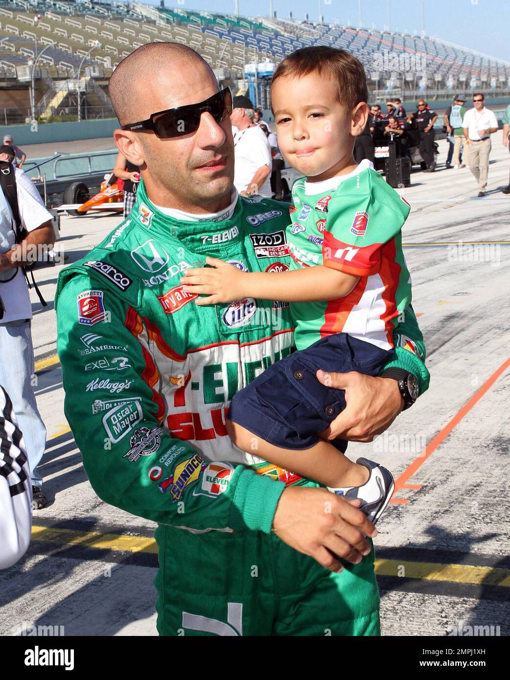 Indy Racing League driver Tony Kanaan enjoys some time with his young son Leonardo prior to his qualifying run during the Cafe do Brasil Indy 300 held at the Homestead-Miami Speedway.  Tony held Leonardo and playfully put the little one, clad in big earmuffs, in to his car. Homestead, FL. 10/01/10. Stock Photo