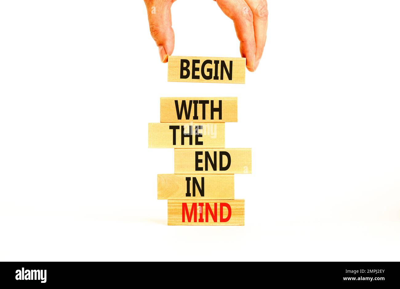 Begin in end of mind symbol. Concept words Begin with the end in mind on wooden blocks. Beautiful white table white background. Businessman hand. Busi Stock Photo