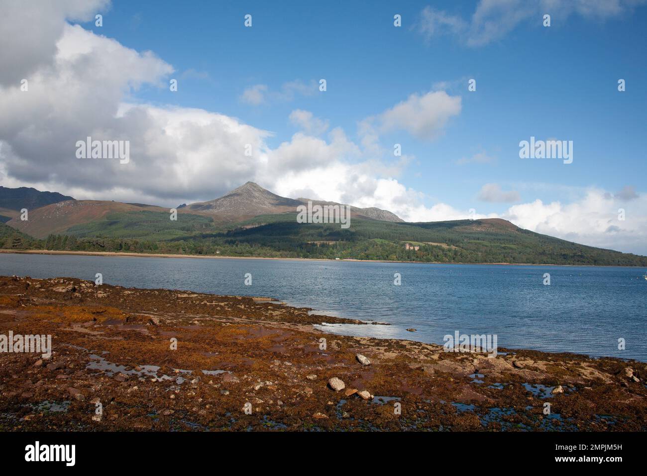 Goat Fell and Brodick Castle viewed across Brodick Bay from Brodick seafront Brodick the Isle of Arran North Ayrshire Scotland Stock Photo