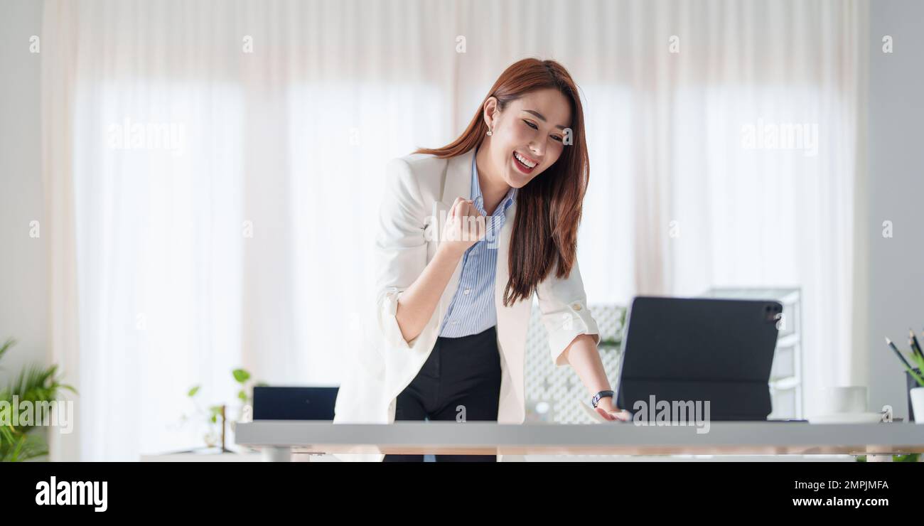 Business woman video call with her business team and excited when have good news. Success and Achievement concept. Stock Photo