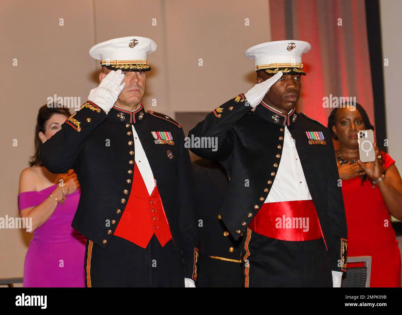 U.S. Marine Corps Brig. Gen. Walker M. Field, left, Marine Corps Recruit Depot Parris Island and Eastern Recruiting Region commanding general, and Maj. Dwayne Littlejohn, right, Recruiting Station Fort Lauderdale commanding officer, salute the colors during the 247th Marine Corps Birthday Ball at the Hilton Miami Downtown in Miami, Florida, Oct. 29, 2022. A celebration for the Marine Corps birthday is held every year to reflect on the traditions, history, and legacy of the Marine Corps. Stock Photo