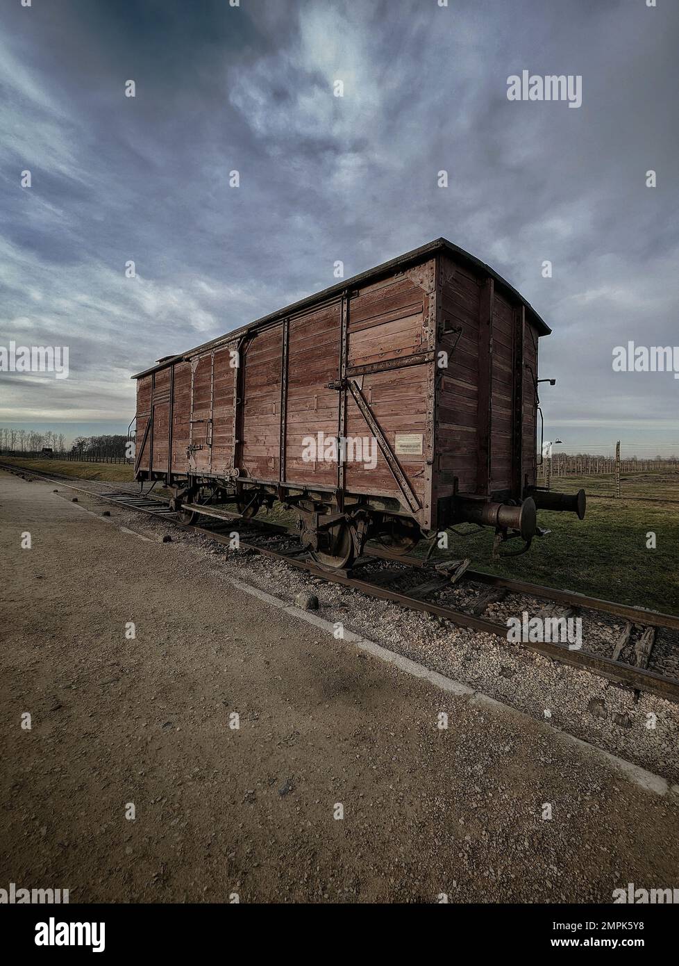 A vertical shot of a wooden wagon used for transporting the prisoners in Auschwitz, Poland Stock Photo