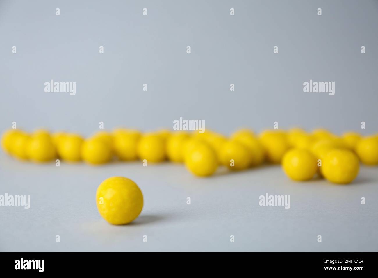 Delicious lemon chewing gums on light grey background, closeup Stock