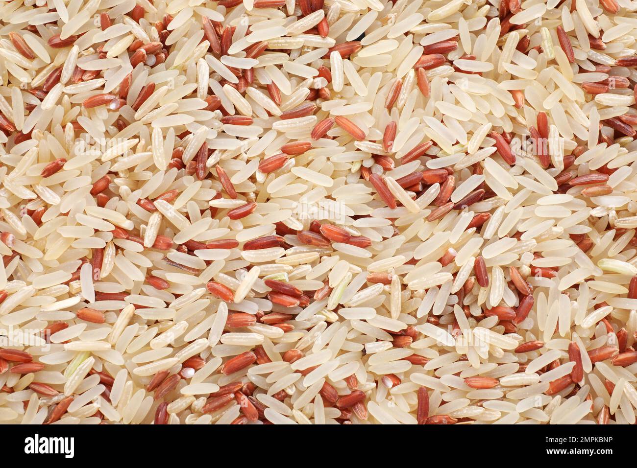 Mix of brown and polished rice as background, top view Stock Photo - Alamy