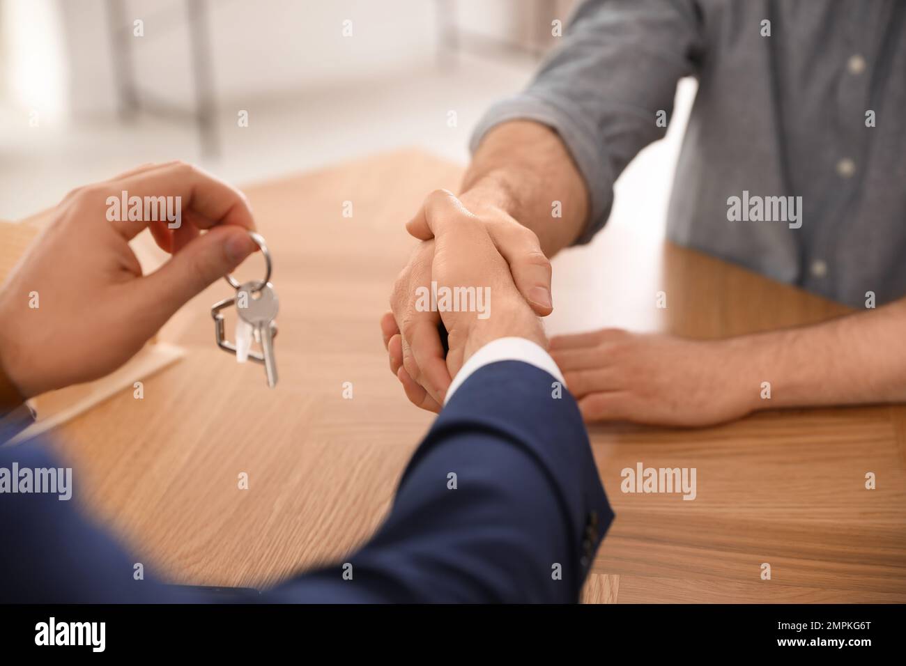 Closeup businessman shaking key in hi-res stock photography and images ...