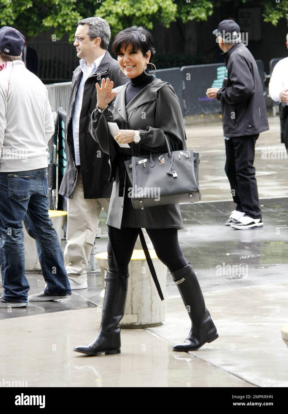 On a rainy afternoon reality TV star Kris Jenner dresses for the weather in  riding boots and trendy grey trench coat at the Staples Center to watch the  Boston Celtics vs Los