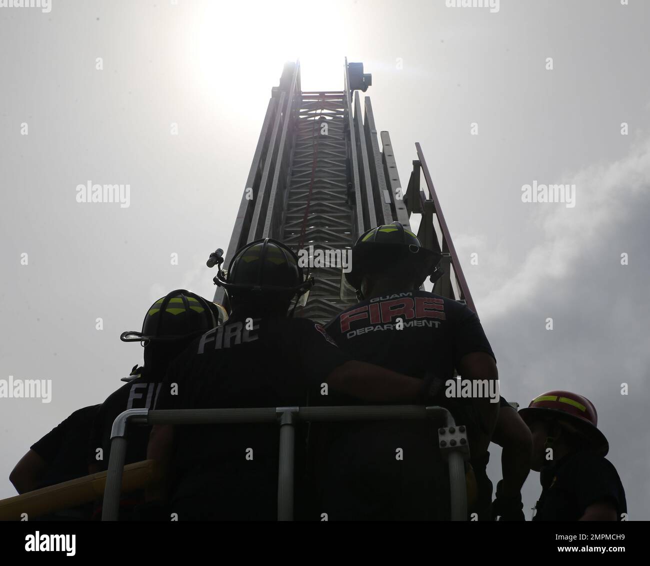 Firefighters operate a ladder truck during joint training on Marine