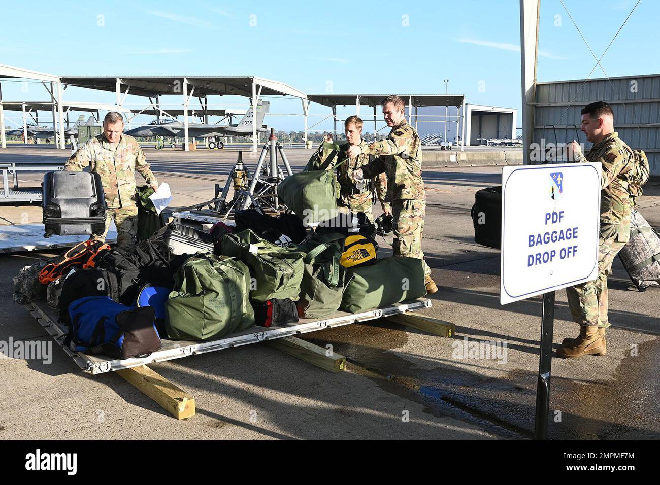 Airmen from across the 159th fighter wing palletize personnel bags as