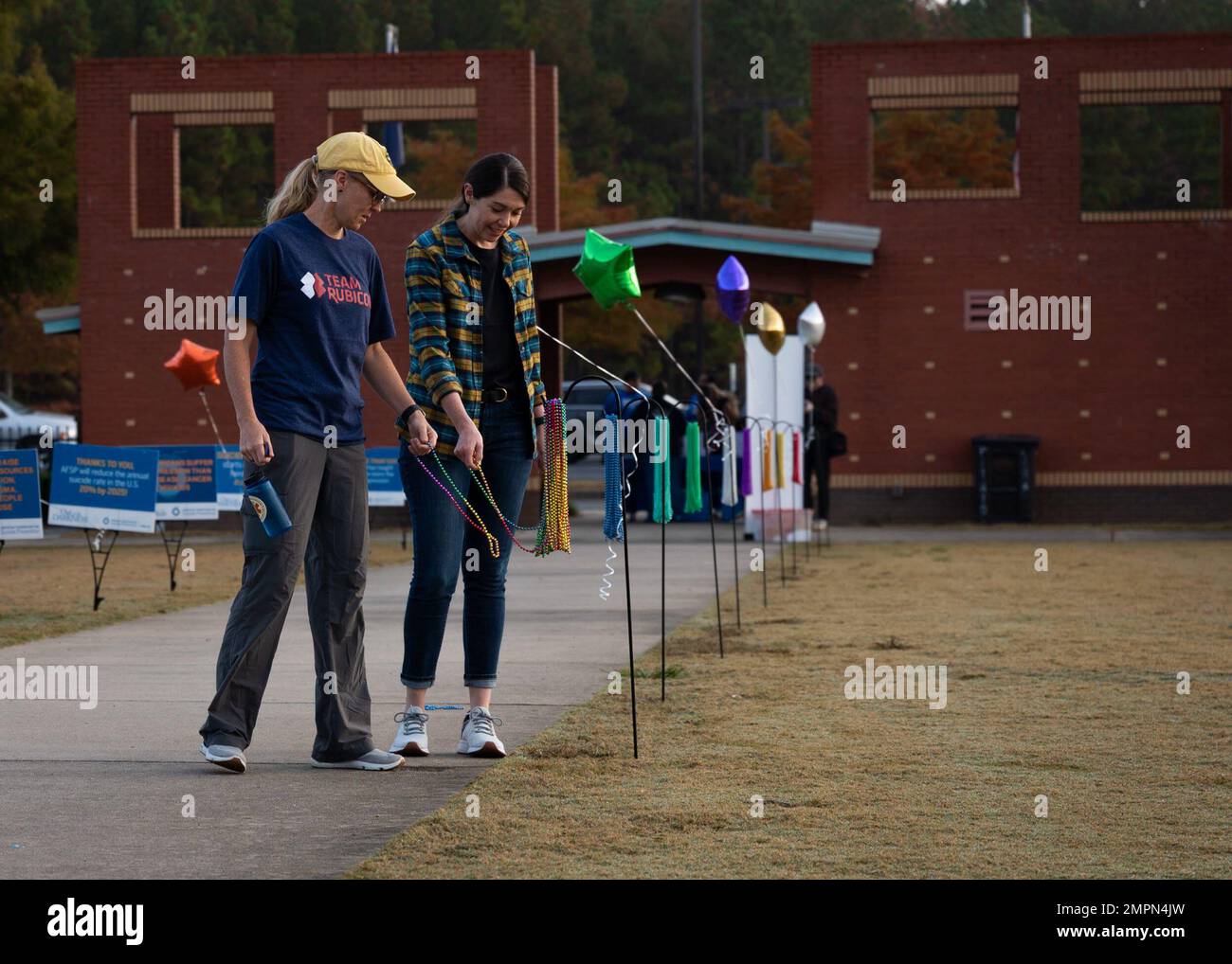 Participants of the “Out of the Darkness'' walk grab rainbow beads