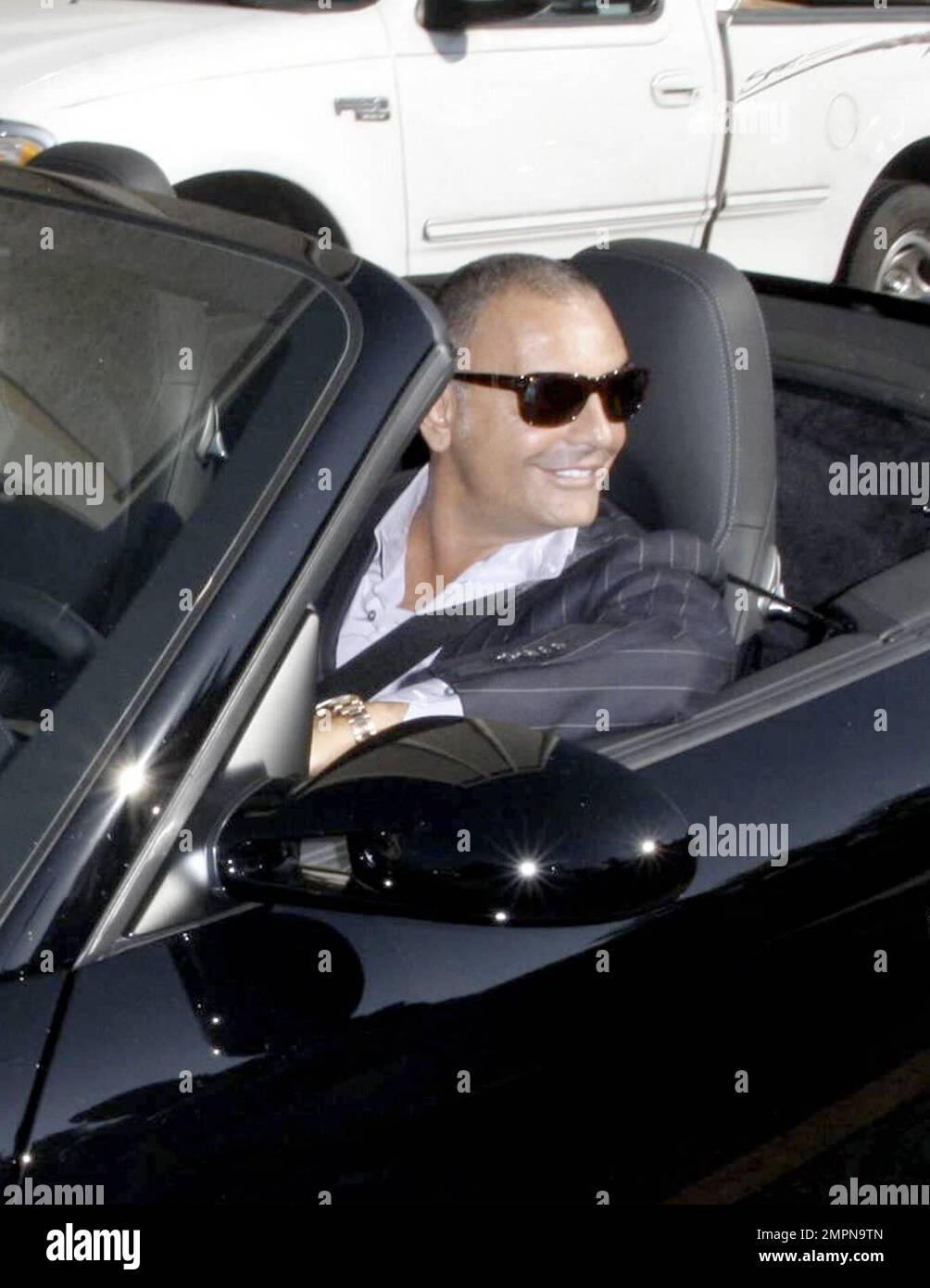 Christian Audigier stops by and talks to photographers while out and about driving in Los