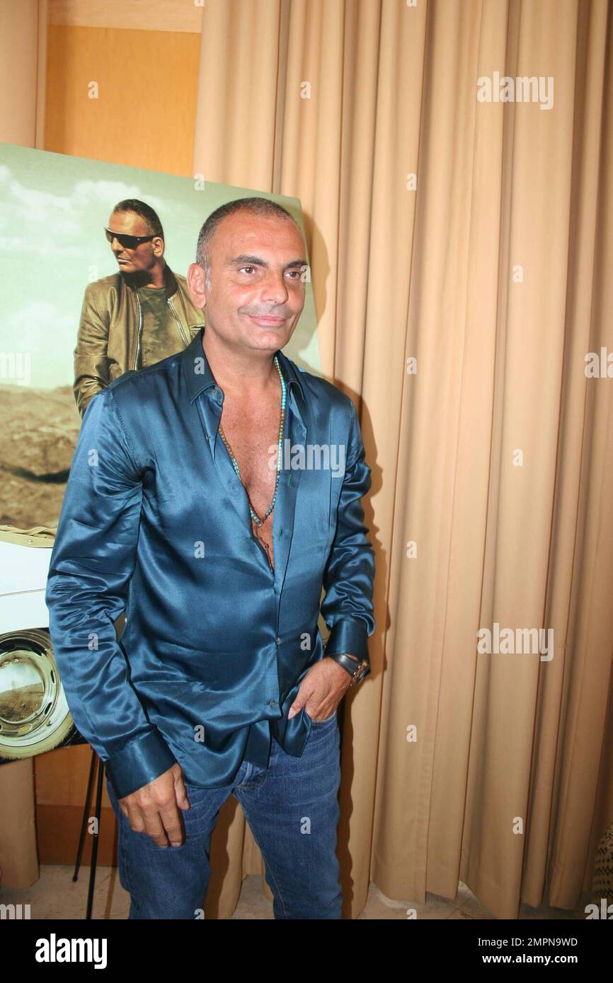 Christian Audigier poses for photos during a press preview shoot during