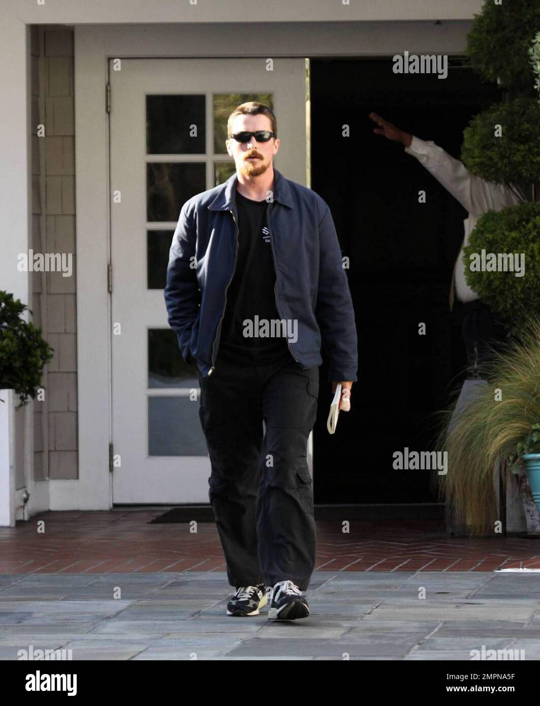 Exclusive!! Christian Bale leaves a lengthy meeting at an LA hotel holding a copy of Deerhunting with Jesus by Joe Bageant whith a heavily bandaged left forefinger. No Batmobile today as the Batman star spent the next hour on the phone in his V6 Toyota Tacoma flatbed truck, LA, CA, 03/16/09. Stock Photo