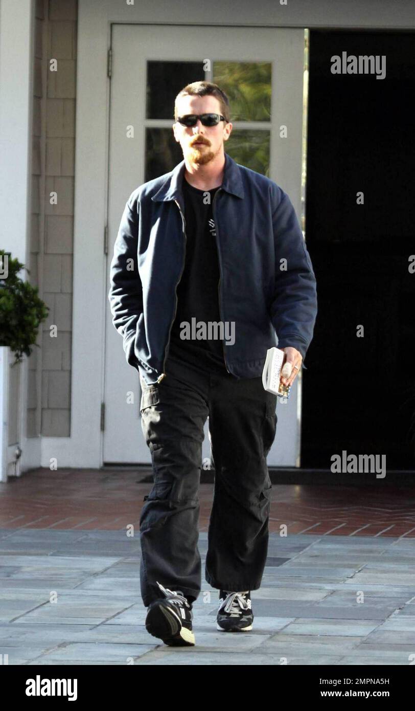 Exclusive!! Christian Bale leaves a lengthy meeting at an LA hotel holding a copy of Deerhunting with Jesus by Joe Bageant whith a heavily bandaged left forefinger. No Batmobile today as the Batman star spent the next hour on the phone in his V6 Toyota Tacoma flatbed truck, LA, CA, 03/16/09. Stock Photo