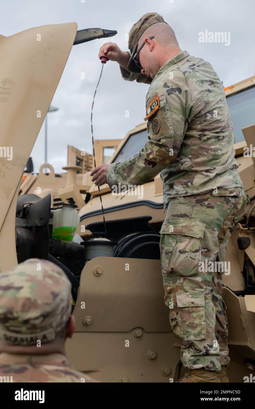 U.S. Army Spc. Skylar Brown, a horizontal construction engineer assigned to Task Force Orion, 27th Infantry Brigade Combat Team, New York Army National Guard, performs a maintenance check on the M1224 MaxxPro mine-resistant ambush protected vehicle in Grafenwoehr, Germany, Nov. 6, 2022. Task Force Orion is deployed to Germany in support of the Joint Multinational Training Group – Ukraine mission. Stock Photo