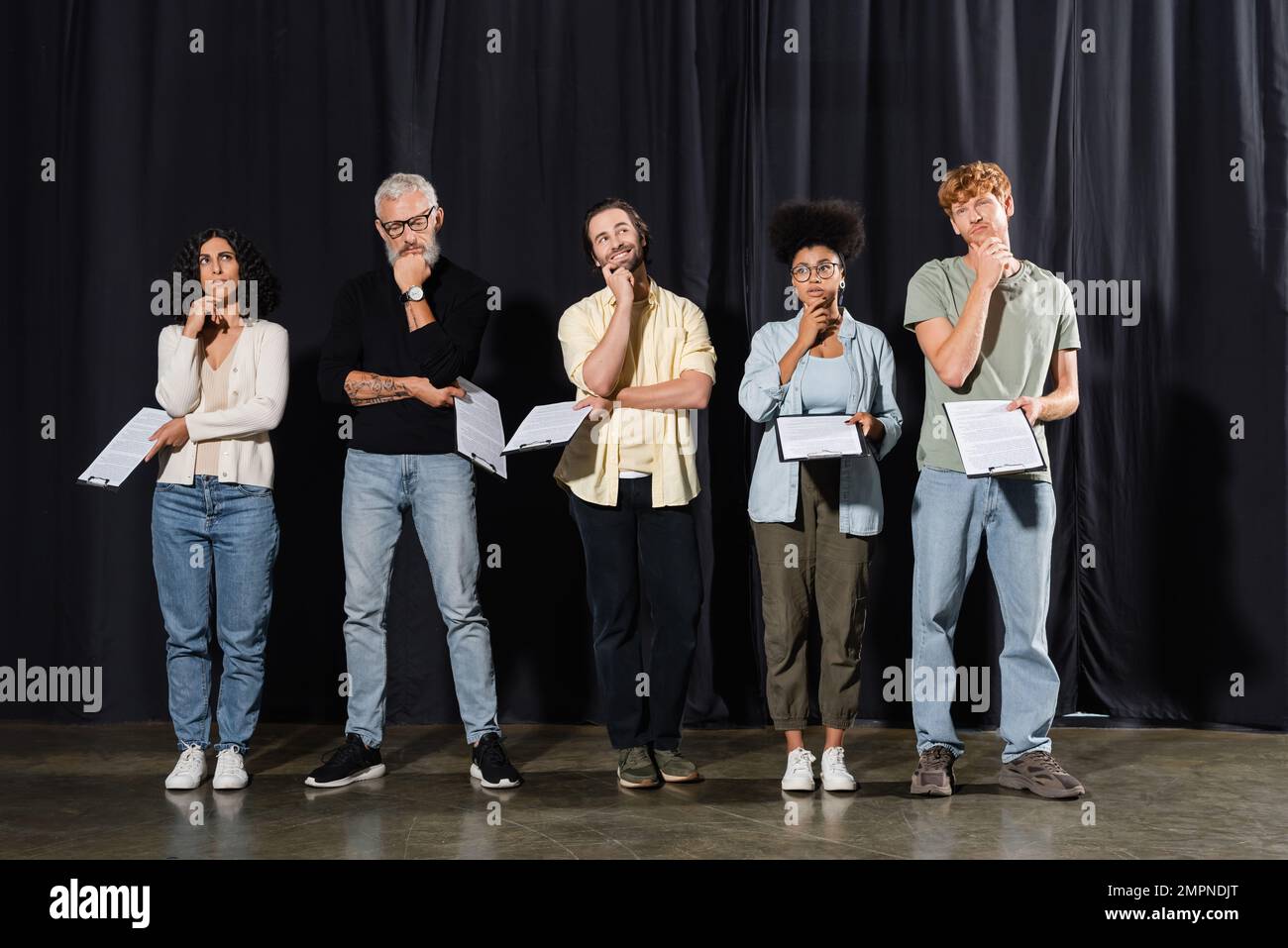 full length of thoughtful multicultural actors with bearded grey haired ...