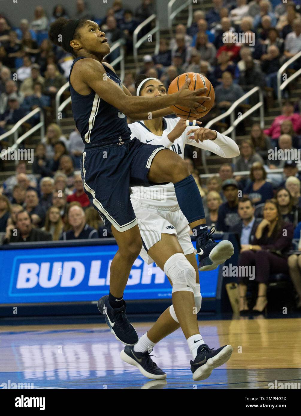 Connecticut's Megan Walker, left, shoots a lay up against Nevada's AJ Cephas (32) in the second