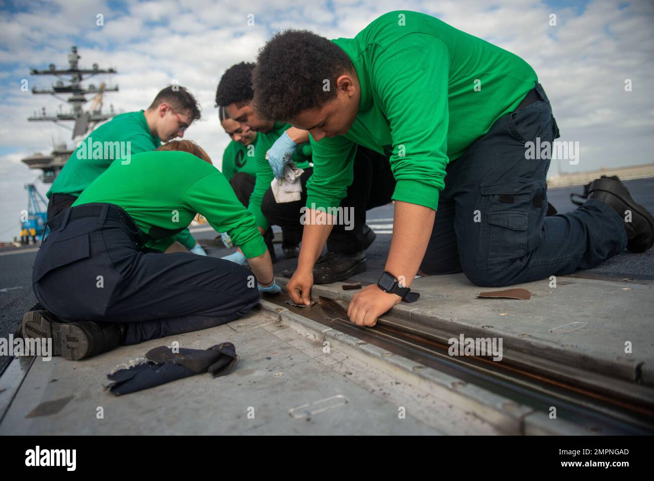 221107-N-MD713-1058 PORTSMOUTH, Va. (Nov. 7, 2022) Sailors perform corrosion control on a catapult on the flight deck aboard the Nimitz-class aircraft carrier USS Dwight D. Eisenhower (CVN 69). IKE is conducting a fast cruise, which is a simulated underway period consisting of drills and training evolutions that test the equipment and systems on the ship to prepare the crew to operate at sea. Stock Photo