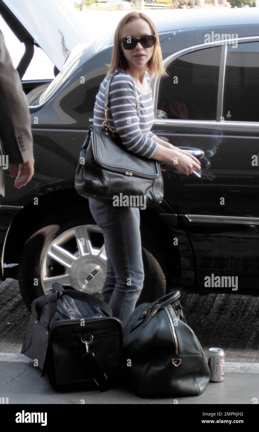 Actress Christina Ricci smoking a cigarette at LAX Airport before ...