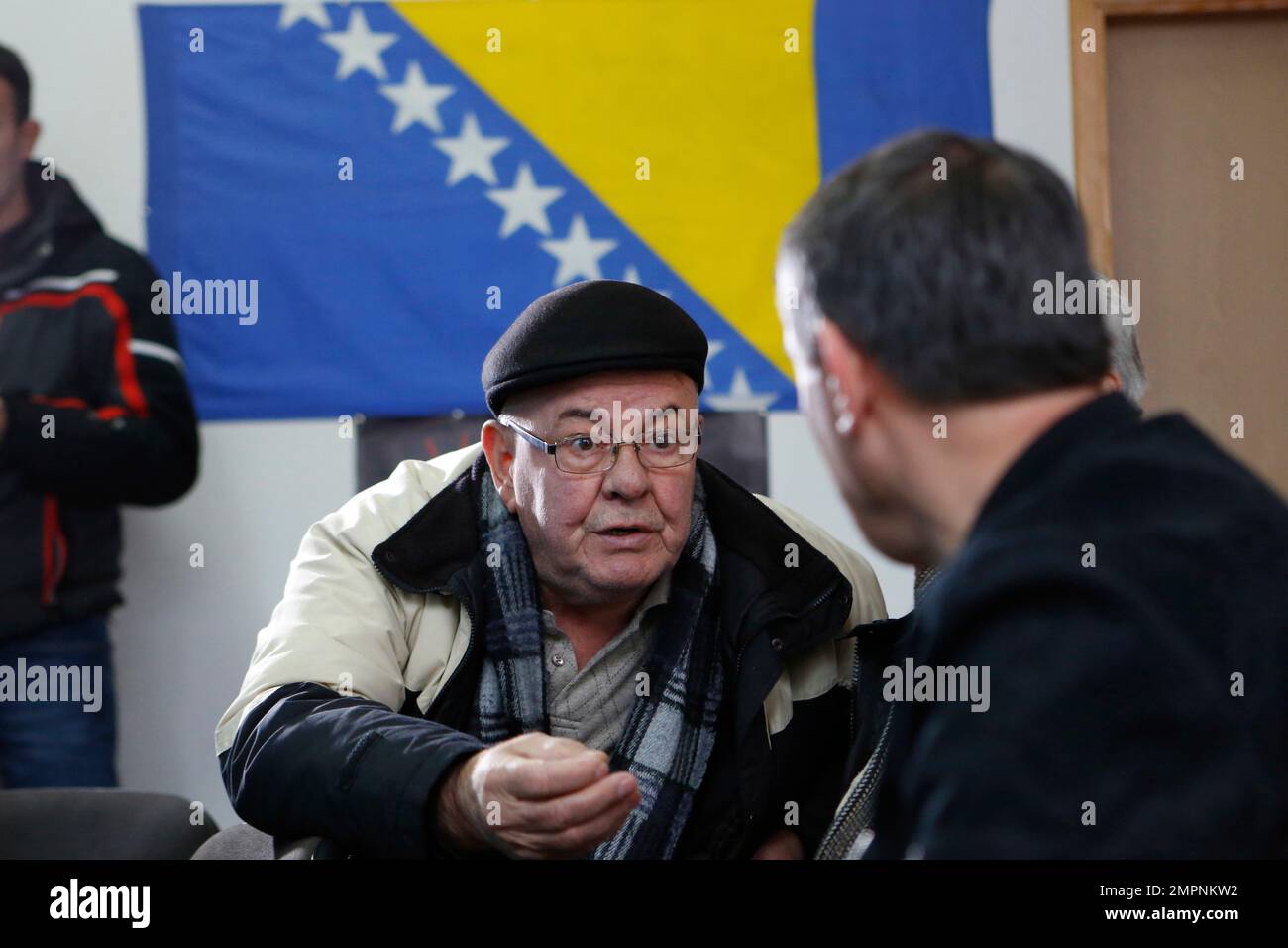 Bosnian people converse as they watch the live TV broadcast from
