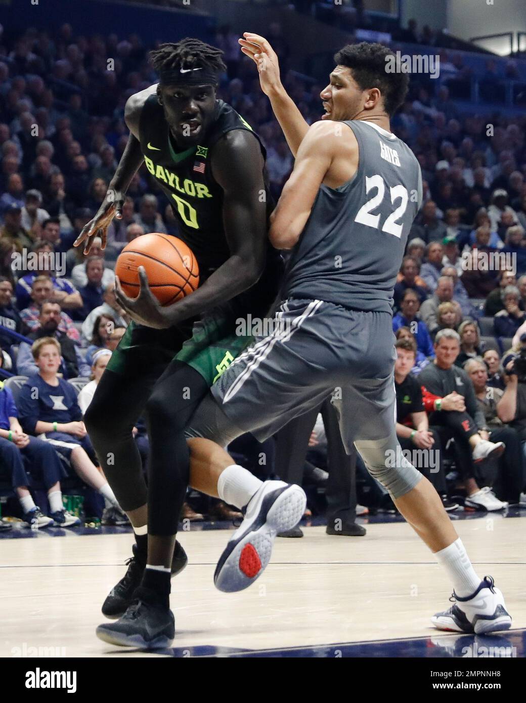 Baylor's Jo LualAcuil Jr. (0) dribbles around Xavier's Kaiser Gates